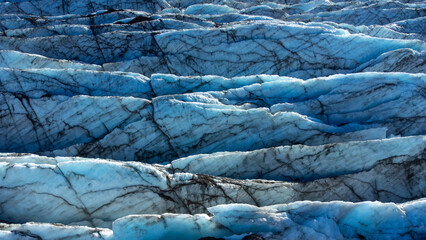 Huge glacier with pure blue ice at sunny weather. Vatnajokull glacier covered snow in Iceland. Beautiful nature abstract background. Ice texture landscape aerial view.