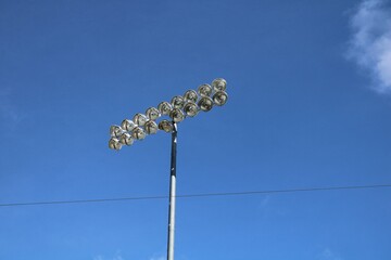 stadium lights against blue sky