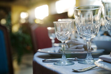 empty wine glasses on the table.table setting for a festive dinner. solar glare.