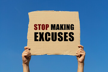 Stop making excuses text on box paper held by 2 hands with isolated blue sky background. This...