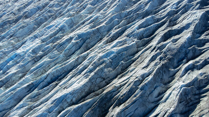Huge glacier with pure blue ice at sunny weather. Vatnajokull glacier covered snow in Iceland. Beautiful nature abstract background. Ice texture landscape aerial view.