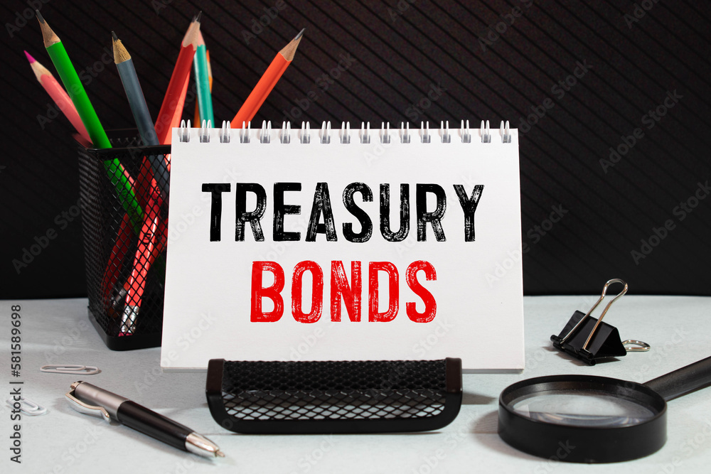 Poster treasury bonds text on paper clipboard with magnifier and keyboard on a wooden background