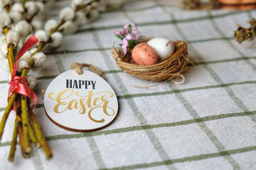 Wonderful Easter decorations. Nest with chicken eggs and willow branches. Happy Easter. Space for text. Easter concept
