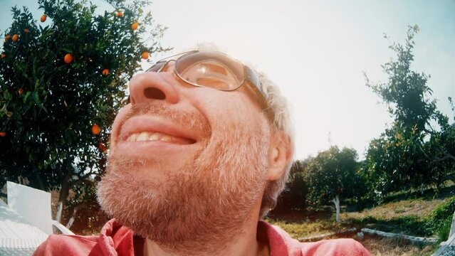 Fisheye lens portait of a happy smiling man wearing big sunglasses