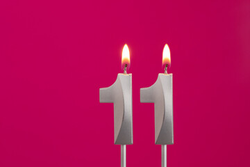 Candle number 11 - Birthday in rhodamine red background
