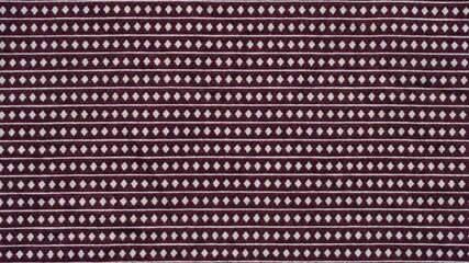 detail of wine red and white rhombus and stripes fabric pattern background