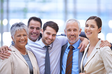 Obraz premium Happy to be part of a team. Cropped portrait of a group of businesspeople standing in the office.