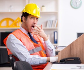 Young male architect working in the office