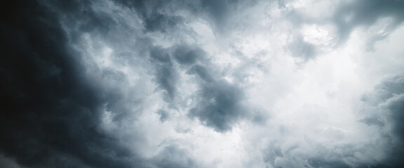 Dramatic cloudscape texture. Dark heavy thunderstorm clouds before rain. Overcast rainy bad weather. Storm warning. Natural gray background of cumulonimbus. Nature backdrop of stormy cloudy sky.