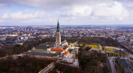 Obraz premium Aerial view of active Catholic Jasna Gora Monastery in Czestochowa on background with modern cityscape in spring, Poland