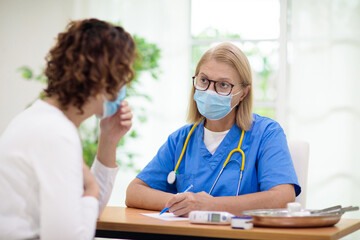 Doctor examining sick patient. Ill woman in clinic