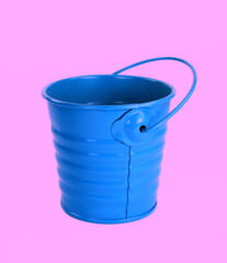 Blue bucket isolated on pink background