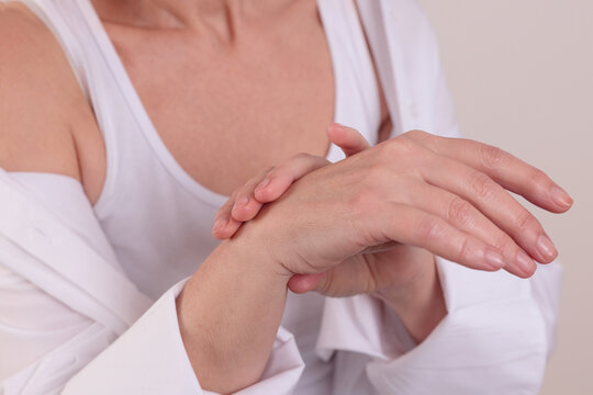 Elderly woman with wrist joint pain close up. Arthritis treatment. Pain relief concept