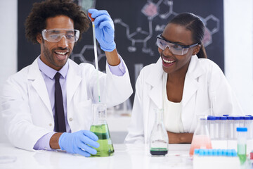 Chemical fun. two scientists conducting an experiment with various chemicals.