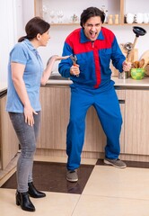 Young male repairman repairing tap