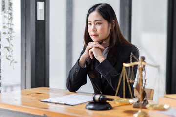 female business woman lawyers working at the law firms. Judge gavel with scales of justice. Legal law, lawyer, documents, advice and justice concept.
