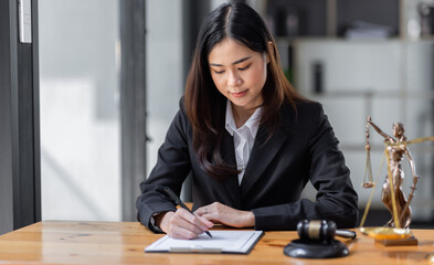 female business woman lawyers working at the law firms. Judge gavel with scales of justice. Legal law, lawyer, documents, advice and justice concept.

