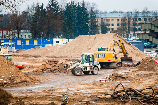 Riga, Latvia, January 31, 2023: Construction work near the Daugava stadium, pictured is a yellow excavator and workers.