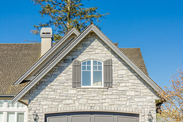 The roof of the house with nice window.