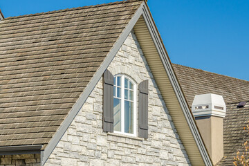 The roof of the house with nice window.