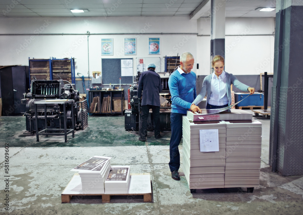 Leinwandbilder checking the latest print run. two colleagues inspecting inventory in a printing factory.