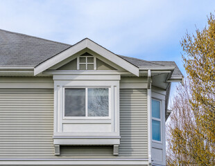Fragment of the house with nice window and green fence