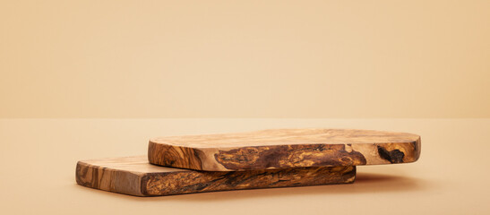 Rustic olive wood podium. Background for products cosmetics, food or jewellery. Front view.	
