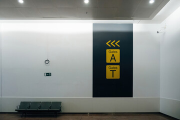 Direction arrows to airport gates a and gates T in modern international airport - empty no passengers