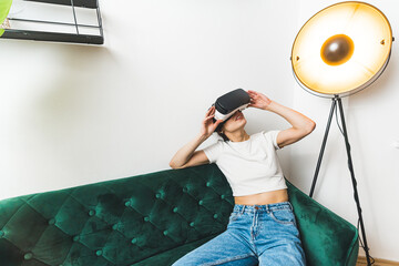 High angle shot. A woman looking up in a VR set on her head. Leisure concept. High quality photo