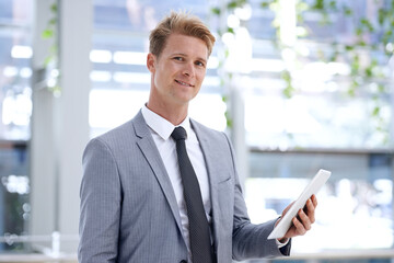 Fototapeta premium He has a drive for business. A young businessman standing in the workplace.