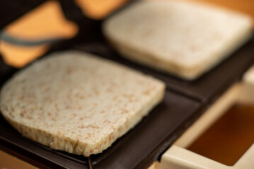 Bread toasted from whole grain flour on a sandwich maker.