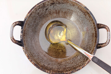 used cooking oil on frying pan. household waste concept