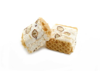 French soft nougat with strawberry flawour and almonds isolated on white background. Greek manolato. White nougat bar isolated.