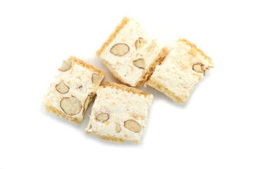 French soft nougat with strawberry flawour and almonds isolated on white background. Greek manolato. White nougat bar isolated.