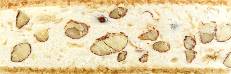 French soft nougat with strawberry flawour and almonds isolated on white background. Greek manolato. White nougat bar isolated.