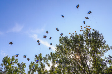 Balloons released into the sky on a festive day.