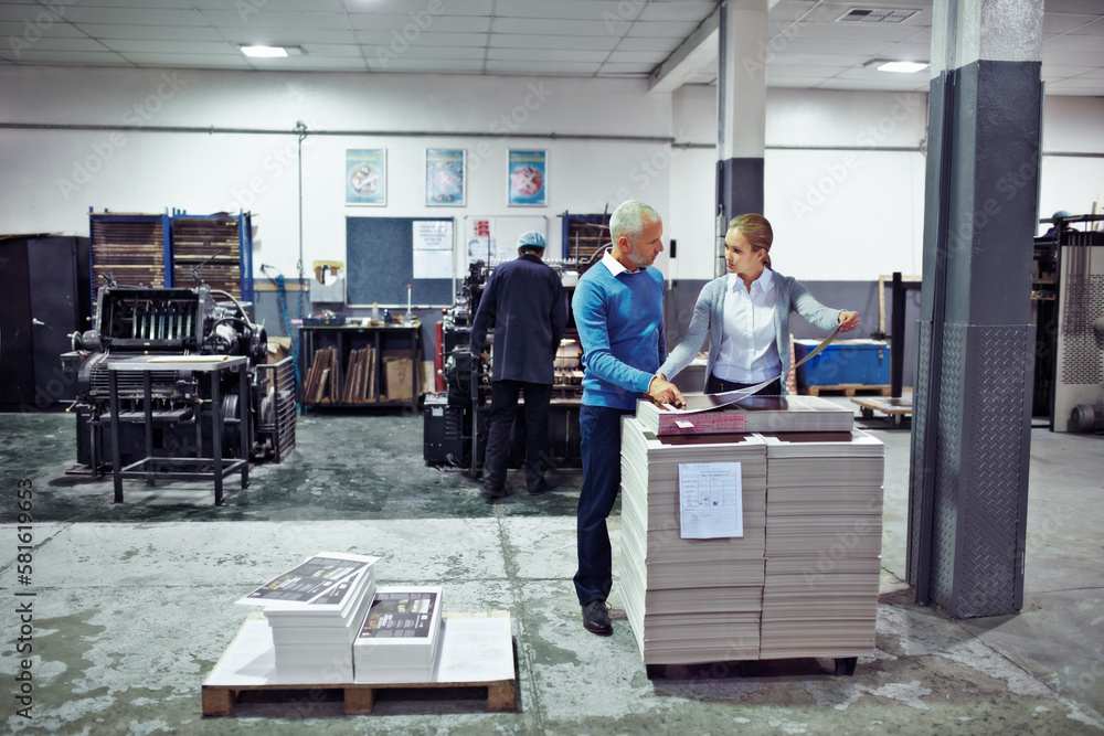 Poster Discussing improvements to production. two colleagues inspecting inventory in a printing factory.