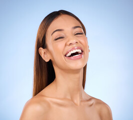 Skincare, beauty and face of laughing happy woman in studio with smile for skin glow promo on blue background. Makeup, facial and cosmetics, African model for dermatology or spa promotion and mockup.