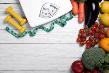 Scales, measuring tape, dumbbells, fresh fruits and vegetables on white wooden table, flat lay with space for text. Low glycemic index diet