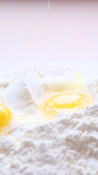 Egg Falling on Flour, Slow Motion 4K. bad shot for a cooking show of egg-flourising wheat flour egg white and egg yolk in one shot eggs fall on the flour and spill around the idea High quality FullHD