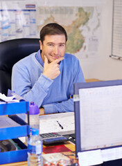 Hes a logistics professional. A cropped shot of a handsome businessman working at his desk.