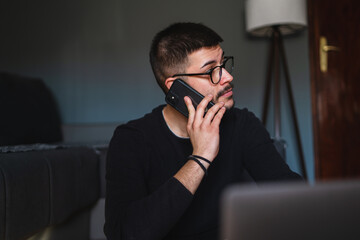 A young guy is using his laptop to study or do business from home	
