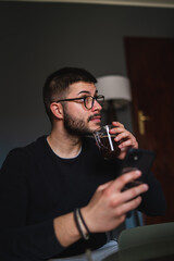 A young guy is using his laptop to study or do business from home	
