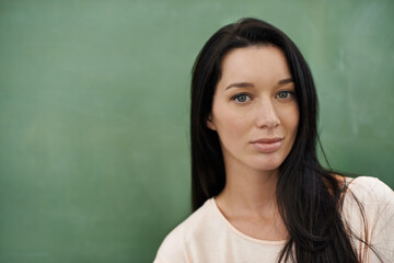 Beauty by the blackboard. A beautiful young woman standing in front of a blackboard.