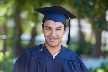He has worked hard for his success. Portrait of a smiling young man on graduation day.