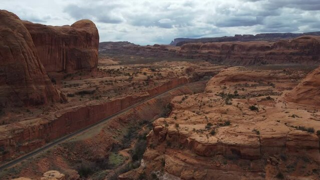 Red Sandstone Cliffs Above Bootlegger Canyon And The Potash Railway In Utah, USA. Aerial Shot