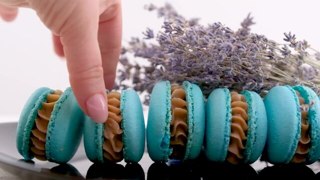on a black plate in row lie blue macaroons with blue cheese a lot of toppings delicious I food sweets dessert