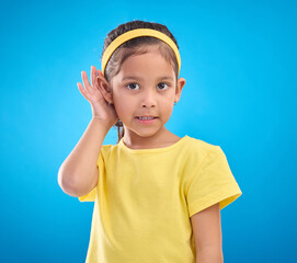 Hearing, eavesdrop and portrait of a children listening isolated on a blue background in a studio....