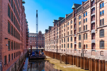 View of canal and historic buildings in old warehouse district Speicherstadt in Hamburg, Germany