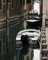 beautiful water channel with moored boats in Venice Italy